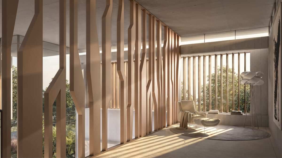 Interior view along a screen of carved vertical elements shaped like slender trunks, low sun raking through them and striping the floor with shadow.